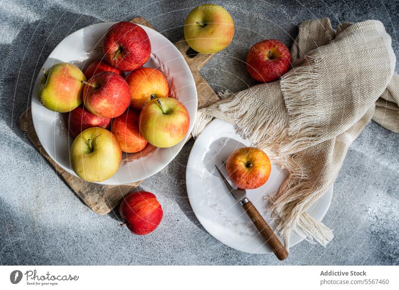 Apples on rustic setting apple ripe colorful wood board plate white fork fabric kitchen fruit red yellow seasonal fresh nature organic food healthy snack diet