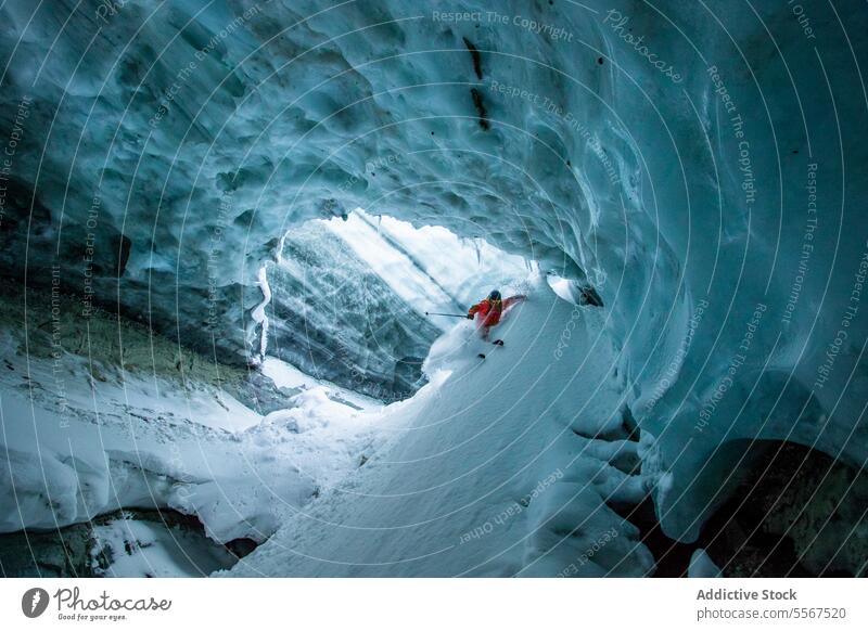 Skier with ski poles exploring cave on during vacation unrecognizable skiing skier slope snowy mountain active exploration nature person warm suit winter