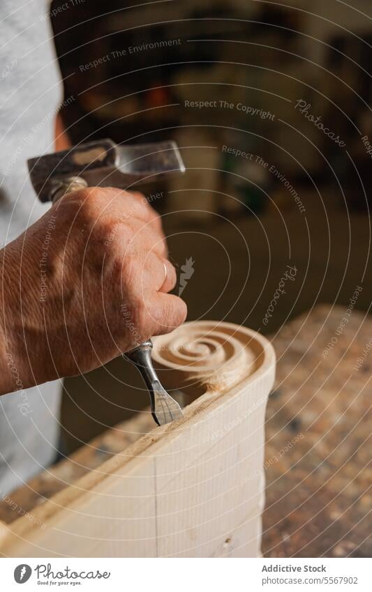 Unrecognizable Carpenter chiseling wood in Toledo carpenter man workshop elderly carving skill craft tool workbench artisan manual male labor expertise design