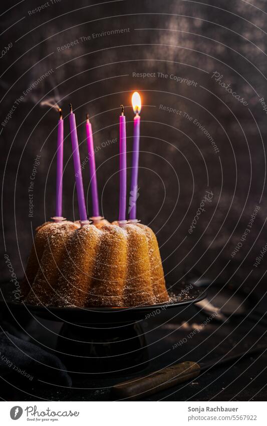 A bundt cake with a burning candle. Still life. Gugelhupf shoulder stand Burn Birthday Feasts & Celebrations Dessert baked Self-made Cake cute Delicious