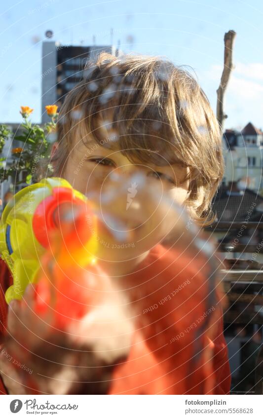 Child shoots with water pistol Water pistol Shoot Brash game fun Happiness Infancy Playing Boy (child) Face Direct Summer Aim Inject spray pistol