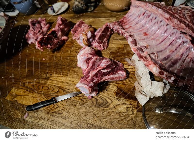 Raw beef tenderloin lies on a cutting board and spices for cooking on a  black table, top view - a Royalty Free Stock Photo from Photocase