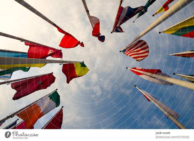 International flags waving in the wind Ensign Flag Blow Sky Clouds Worm's-eye view Nationalities and ethnicity Wind Politics and state Flagpole Hospitality