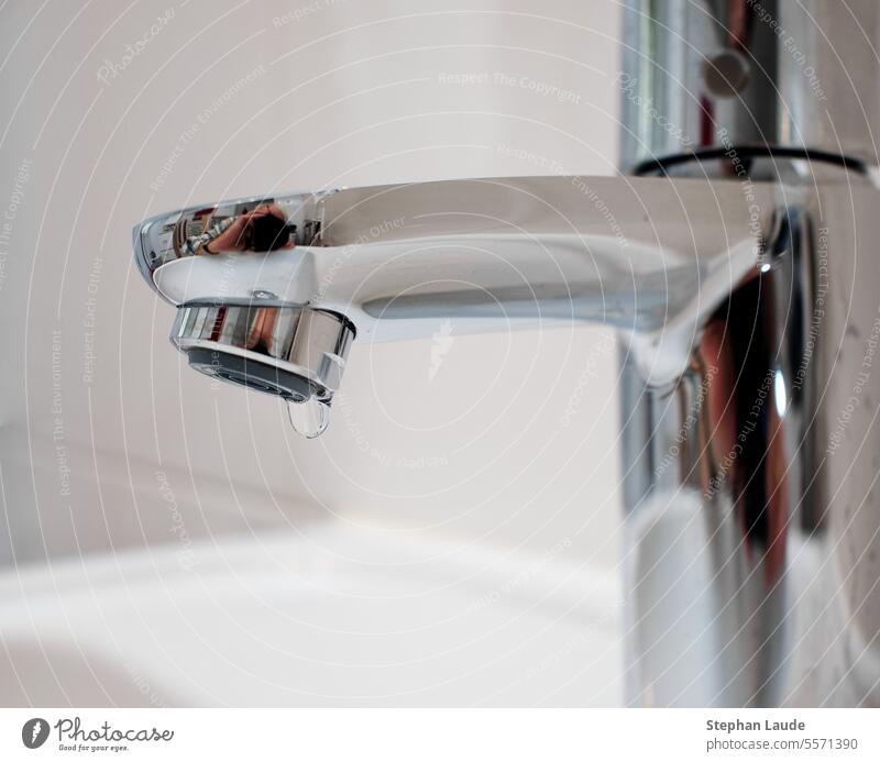 Photographer reflected in dripping faucet Tap Bathroom bathroom Fittings reflection self-portrait Take a photo camera Chrome Glittering Drop Drops of water Sink