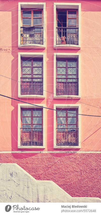 Street view of an old colonial building facade in Quito, color toning applied, Ecuador. city retro architecture filtered travel house vintage wall window