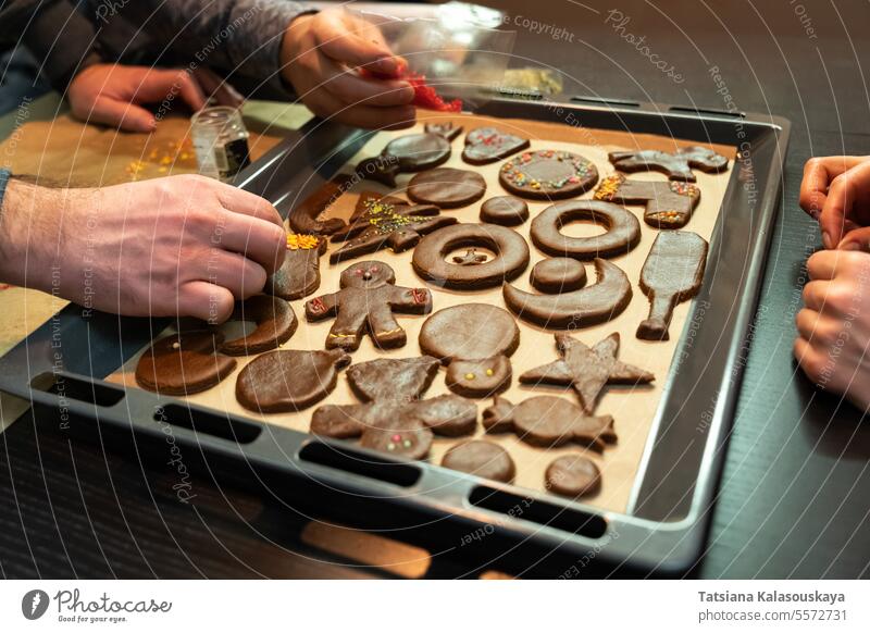 A group of friends prepares ginger cookies of different shapes before Christmas gingerbread cookies sweets Cookie Sweet Food Dessert Baked Pastry Item