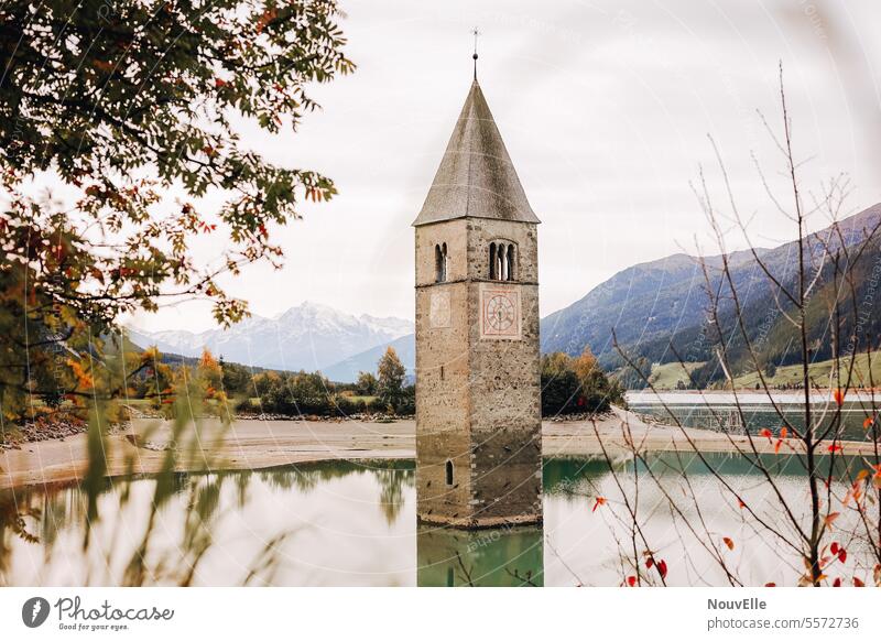 Atlantis. Lake Reschen Resia Vinschgau grey South Tyrol submerged Church spire Mountain Mountains in the background