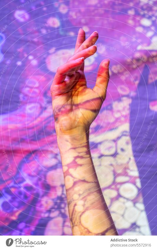 Painted hand signaling peace in cosmic realm paint gesture swirl pattern spiritual enlightenment mental well-being abstract color art meditation introspect
