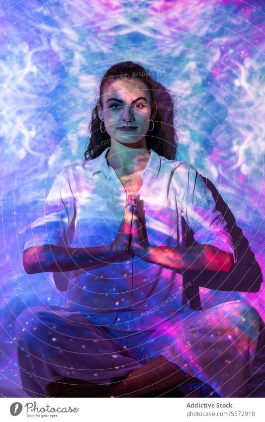 Woman channeling energy in cosmic meditation for inner well-being woman tranquil spiritual mental prayer emotion balance therapy dream universe aura introspect