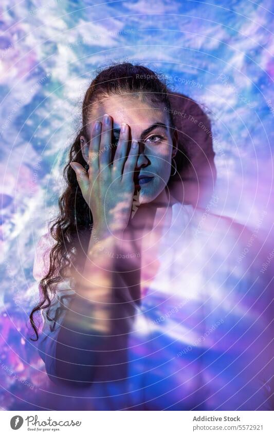 Woman in quest for inner clarity in a cosmic introspective stance woman introspection spiritual mental hand eye challenge balance universe aura emotion journey