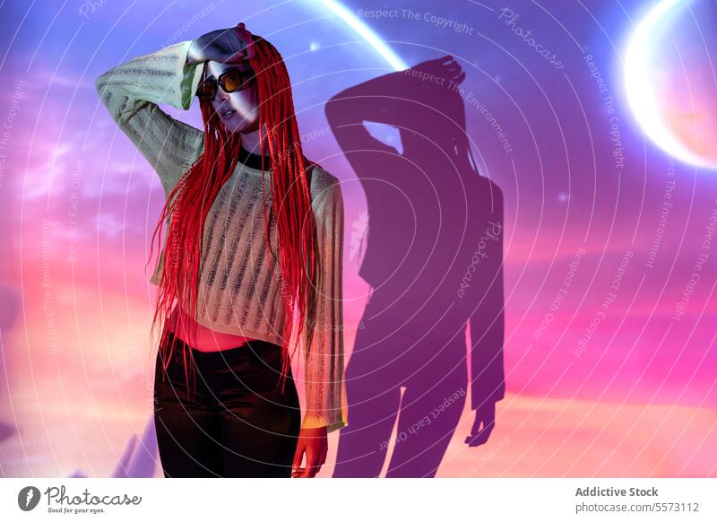 Woman with orange braids standing in neon lights woman young portrait metaverse afro braids abstract projector virtual futuristic appearance augmented reality