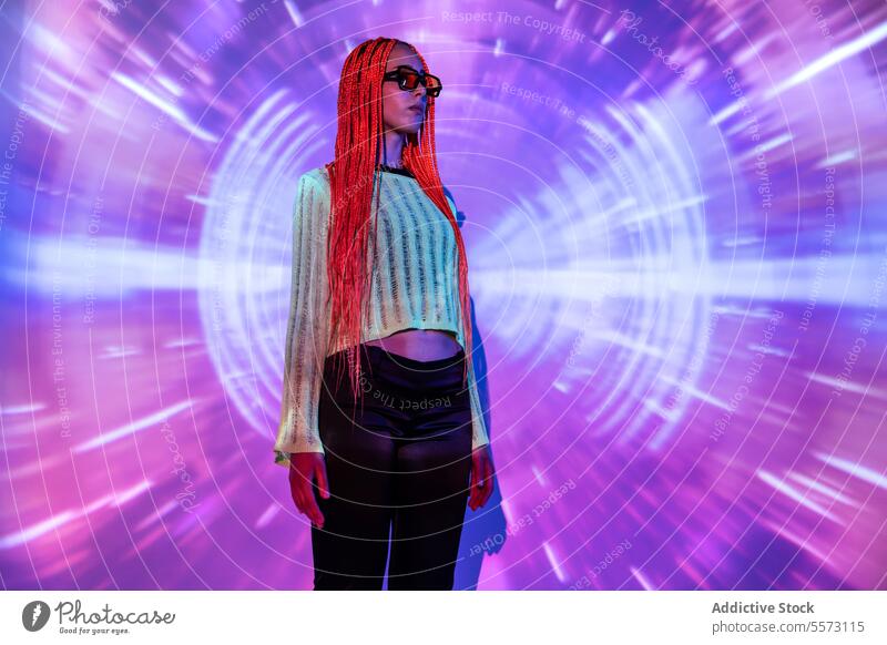 Woman with orange braids standing in neon lights woman young portrait metaverse afro braids abstract projector individuality virtual futuristic appearance
