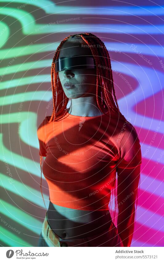 Woman exploring cyberspace in VR glasses woman vr headset calm orange braids experience augmented virtual futuristic metaverse young cool studio shot innovation