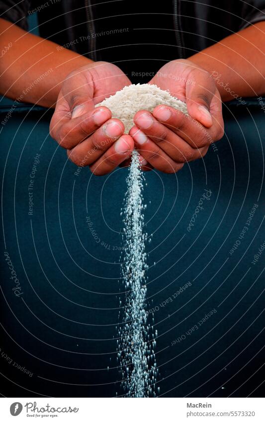 Rice trickles through the hands Handful of rice Interior shot food products Eat Drink grain grains staple food