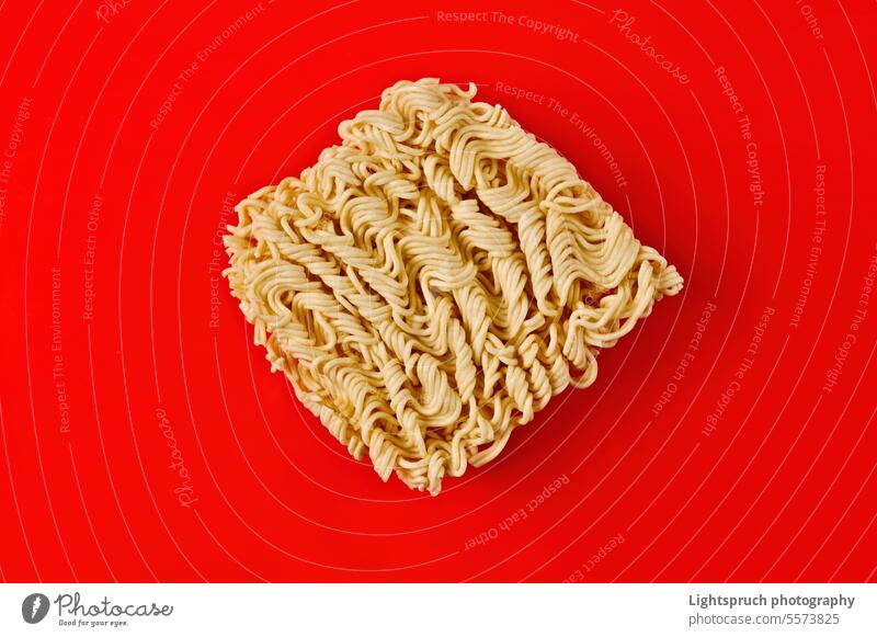 Block of instant ramen noodles on red background. isolated asia east asian culture japanese food close-up raw food cultures convenience crockery