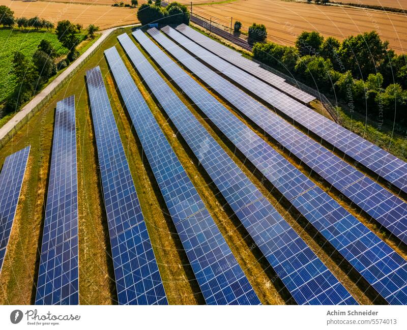 Solar park with solar modules in the landscape next to a railroad line plant Germany Energy Energy production energy revolution Field Climate change Landscape
