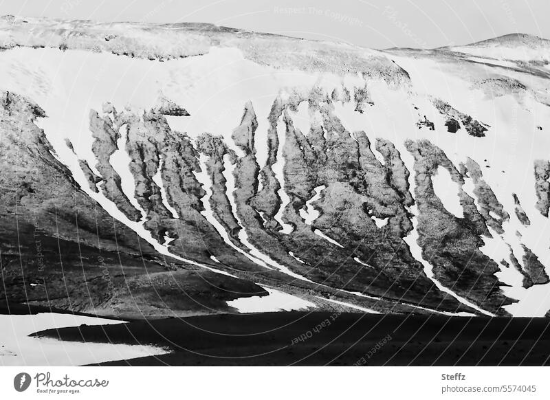 View of a mountain side with snowmelt in Iceland North Iceland Snow melt Mountain side Hill side rocky residual snow Snow forms Iceland weather shape Mysterious