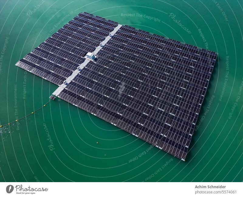 Aerial view of a solar park with solar panels in the water of a lake floating photovoltaic aerial view solar farm solar power plant floating PV many