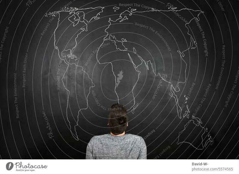 Man in front of a huge world map Map of the World thoughts Meditative Fear of the future Environment Ambiguous Continents Destruction Poverty