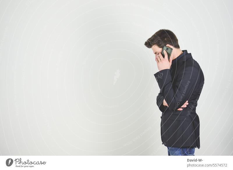 Man on the phone with cell phone in hand Cellphone Business make a phone call conversation hollowed smartphone Telephone Businessman Copy Space Neutral