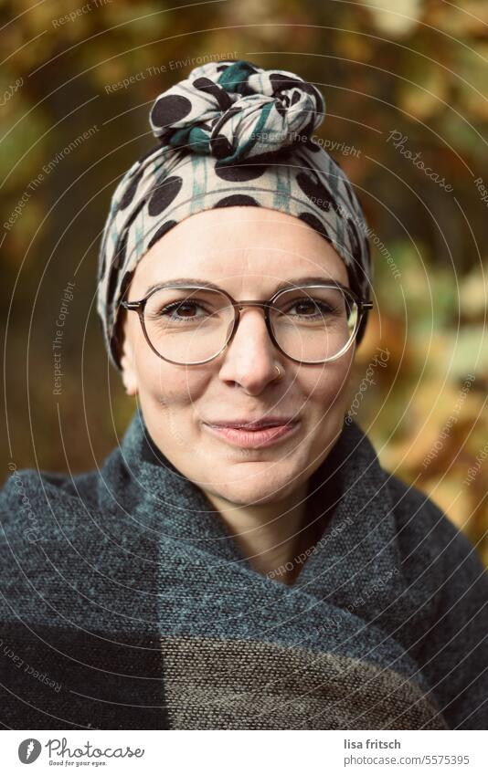 GRIN - DIMPLE - OF COURSE Woman 25 to 30 years Eyeglasses portrait Headscarf Grinning pit Autumn naturally Close-up Adults Colour photo youthful feminine pretty