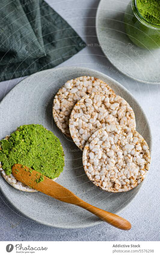 Dieting breakfast with rice bread and spinach pesto pasta-sauce Rice green spread plate glass jar vibrant food healthy snack dip table texture organic natural