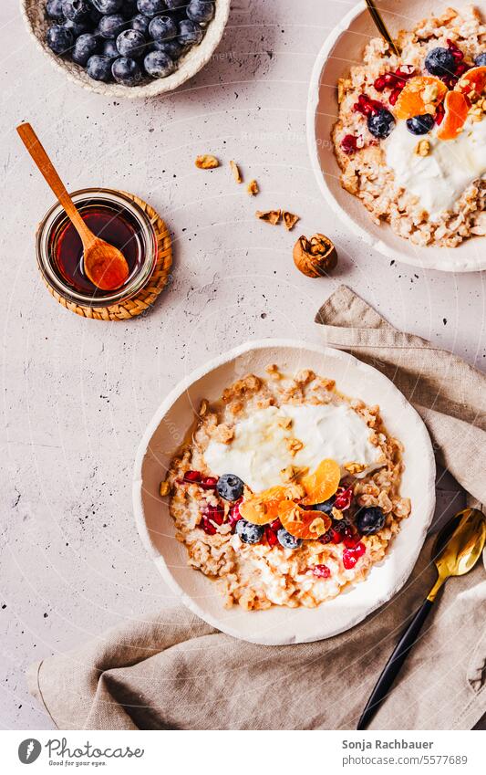 Warm porridge with mandarins and blueberries in a bowl. Top view, breakfast. warm Breakfast Tangerine blueberry Honey Milk Bowl Nutrition Food Healthy Fruit