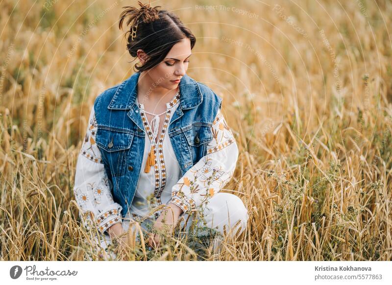 Pretty modern hippy woman in wheat field. Young lady in ethno embroidery shirt happy ukrainian young beautiful beauty female girl person stylish portrait