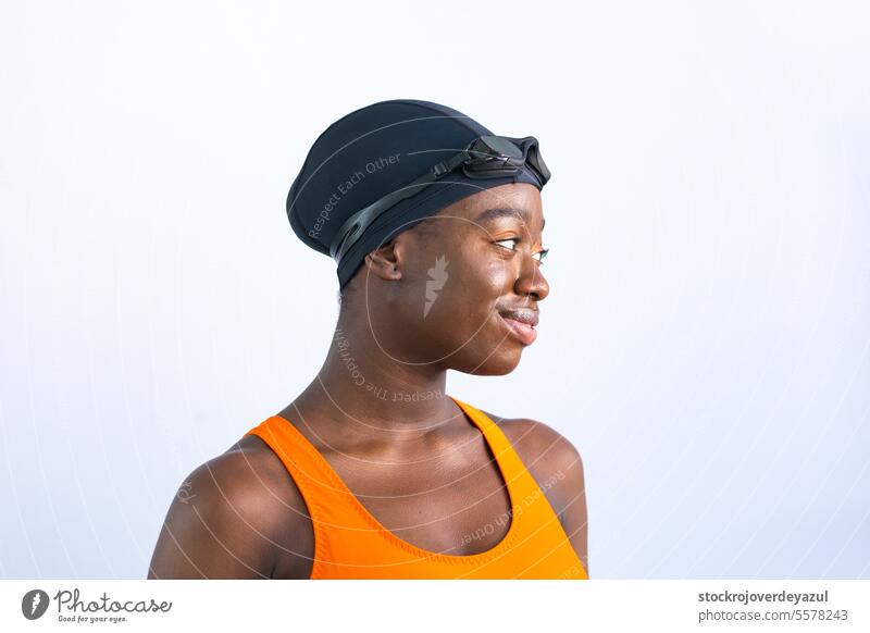 Portrait of a black young woman in swimsuit with plain white background person female swimming pool heated orange healthy smiling blue happiness lifestyle sport