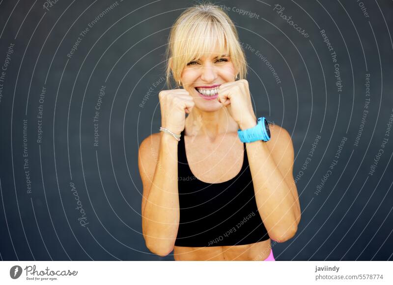 Smiling woman practicing martial art punch in gym fitness happy smile strong workout confident practice activity physical strength wellness energy healthy