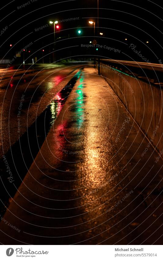 In the evening in the rain on a bridge just before the road junction Rain Street Street lighting Traffic light Traffic lights Green Red Wet reflection
