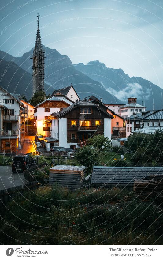Mountain village at dusk with lights - Sent Village houses Church tower Rain Moody Dark Twilight Dusk clearer Window roofs mountains Vantage point sentinel