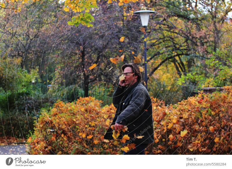 Man talking on the phone in an autumn park Park Autumn make a phone call leaves Nature Tree Leaf To fall autumn mood Berlin Autumn leaves foliage autumn colours