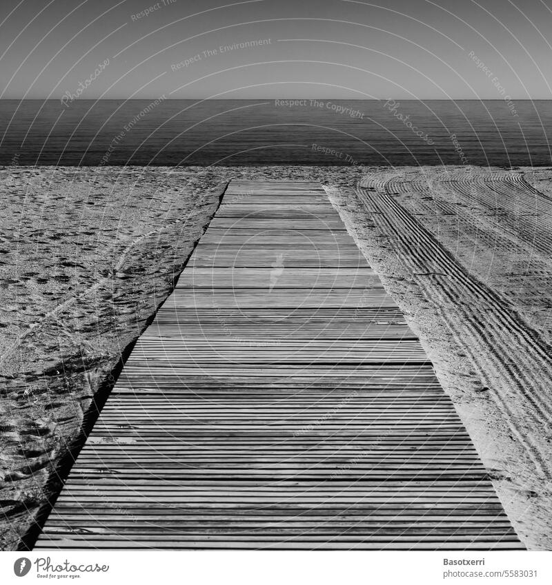 Wooden or concrete jetty, access to an empty beach on the Mediterranean, executed in black and white Beach beach access nobody Ocean Sand Sandy beach coast