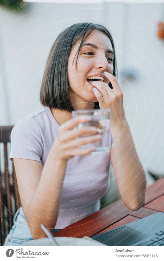 Woman smiling while holding many pills in her open hand, she is about to eat them, supplementing woman happy painkiller vitamin healthy wellness treatment