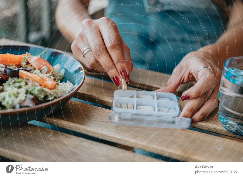 Close up hands taking pills from pill case, supplementing or vitamin medication,disease treatment concept woman happy painkiller healthy japanese lunch person