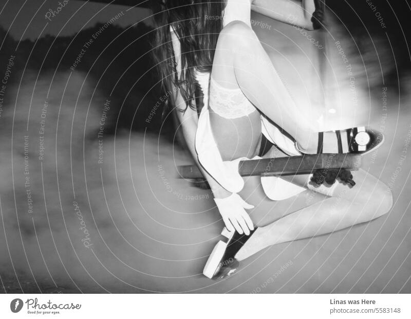 There's a haze concealing a stunning fashionista adorned in a white dress and black lingerie. A shoe fashion model is captured in a dynamic pose, swinging gracefully. Her pretty long legs in white stockings are in the spotlight.