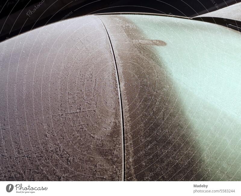 Overnight frost on the windshield and bodywork of a car in winter in Oerlinghausen near Bielefeld on the Hermannsweg in the Teutoburg Forest in East Westphalia-Lippe