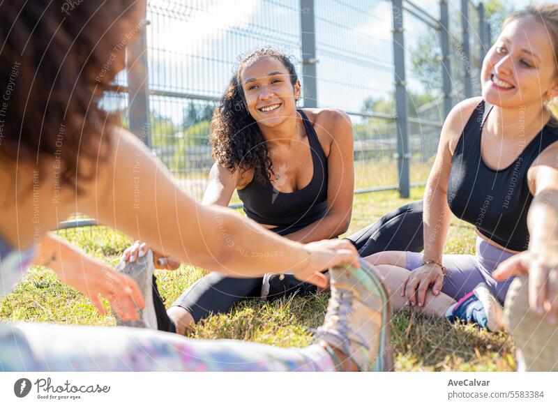 Diverse group of friends training together during sunny day.Body positive all shapes are valid. people adult outdoors woman friendship sitting lifestyles happy
