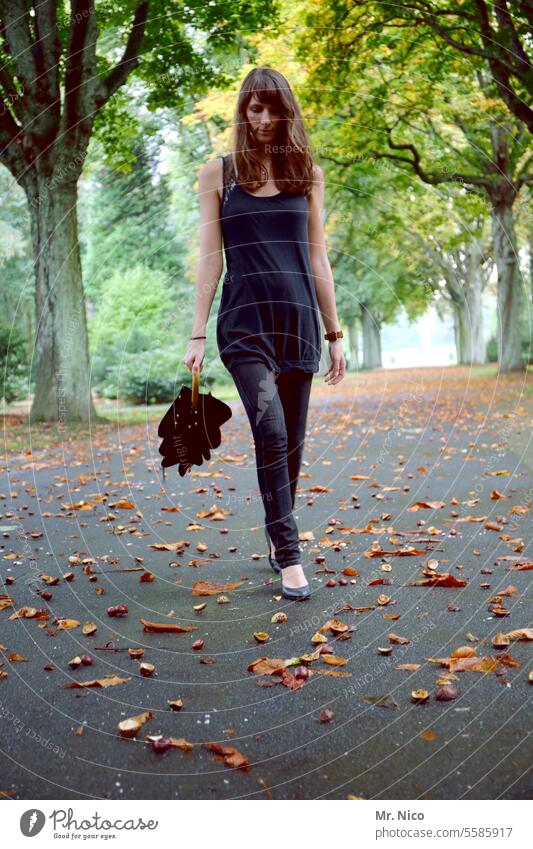 woman take a walk Autumnal Avenue Pedestrian To go for a walk Footpath Relaxation Lanes & trails Park Tree Autumn leaves lowered head Long-haired Umbrella