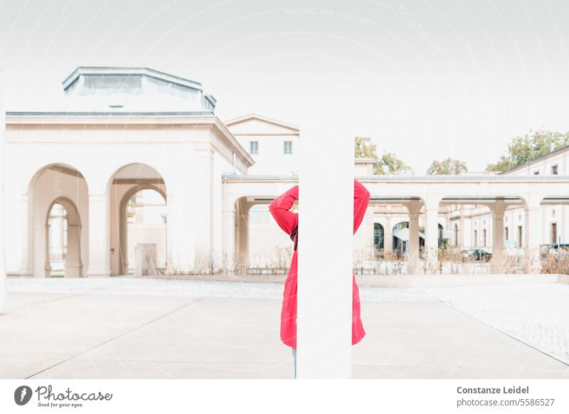 Woman with a red coat behind a white column, heavily overexposed. Red Overexposure Bright Human being White Arcade Experimental Long exposure covert Art