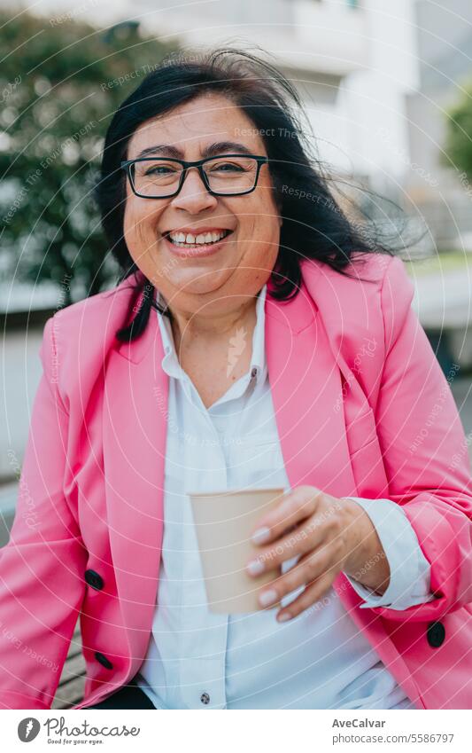 Jubilant woman in modern clothes resting and having coffee before going back to work at the office. happy person women portrait female face smile adult