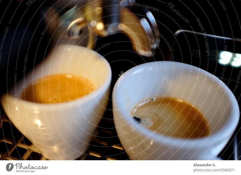 Two espresso cups under a portafilter of an espresso machine Espresso cups Espresso machine screen carrier screen carrier machine Coffee Coffee maker Caffeine