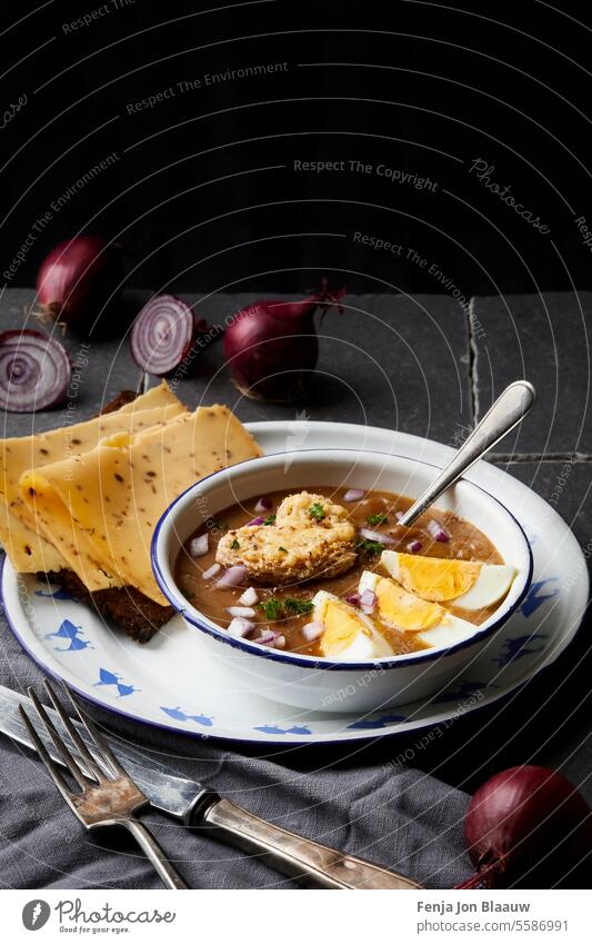 Fresh healthy soup of red onions served with egg and Dutch cheese cooking cut cutting onions dark and moody food photography food styling harvest kitchen