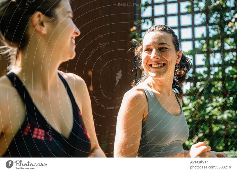 Two happy friends running on a sunny day on wooden walkway with green leaves,leading a healthy life. lifestyle women female young person fitness exercise