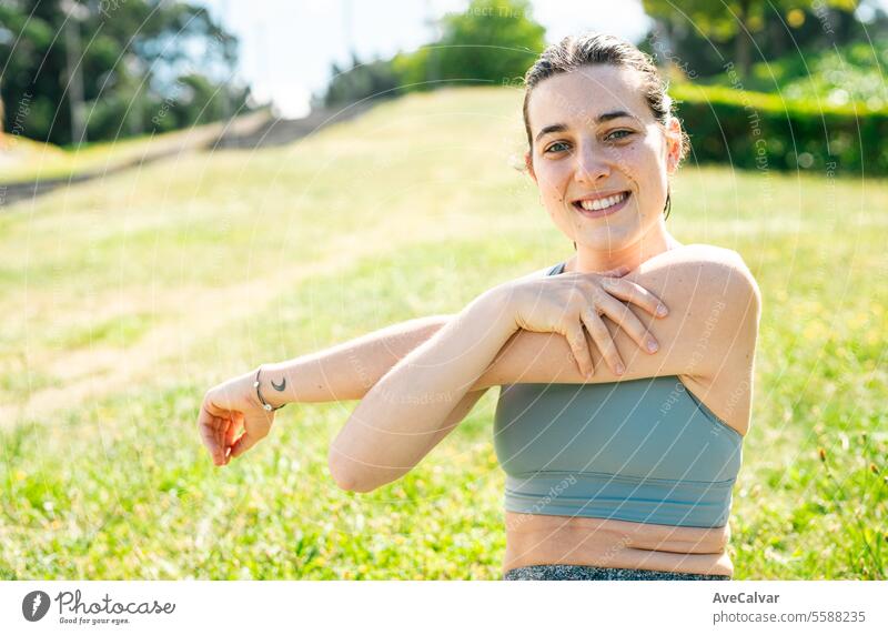 Female sports trainer teaching how to stretch to avoid injuries outside the home. Healthy lifestyle. female woman young summer person adult caucasian nature
