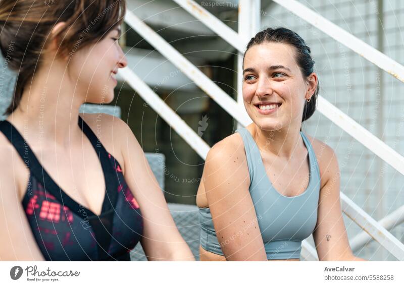 Two women friends talking happily in sportswear ready to do sports together and support each other. fitness healthy exercise female lifestyle young outdoor