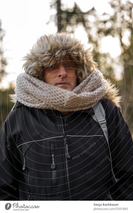 A man with a fur cap and a scarf Man Scarf hood Winter chill Lifestyle Exterior shot portrait see Eyeglasses Human being pretty 50-60 Jacket Black Face Day Cold