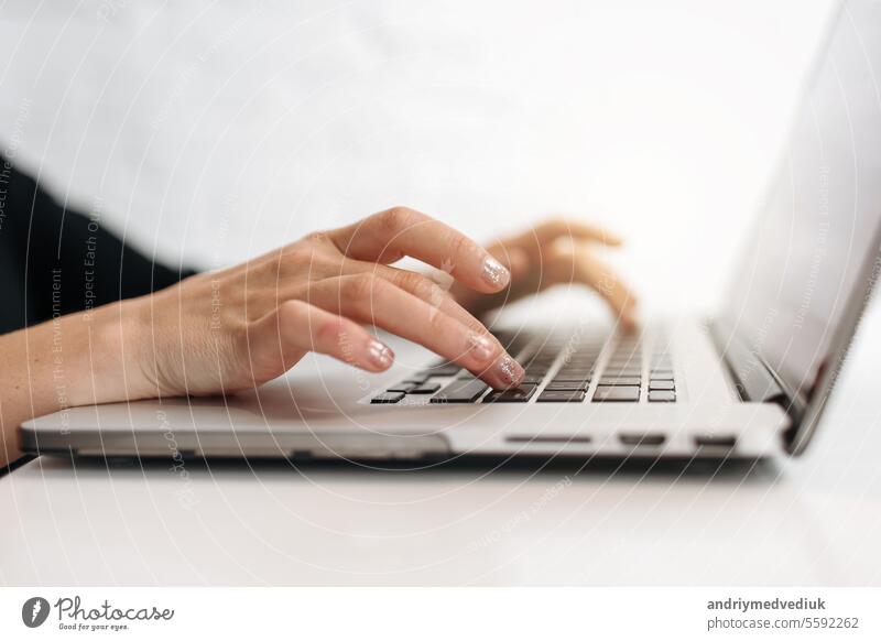 Close up woman's hands typing on laptop keyboard at home office. Businesswoman or student girl using pc for online internet marketing, freelance, work from home, education online, distance studying