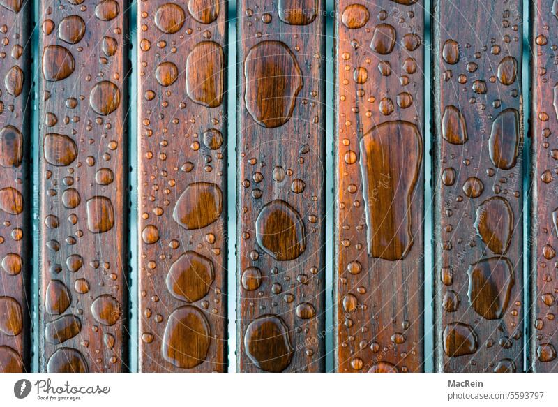 Drops of water on a wooden table Wood Wooden table raindrops Wet